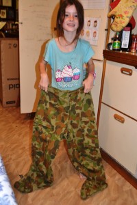 Miss is dwarfed by the army pants.